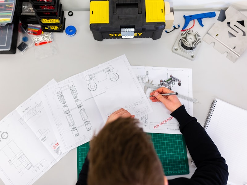 A technician measuring a machined part with a micrometer.